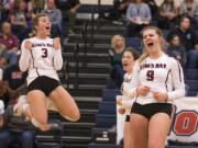 King's Way's Dana Snider (3), from left, Gracie Brown, and Abby Cummins celebrate a point in the first set against La Center at King's Way Christian School on Tuesday night, Oct. 2, 2018.