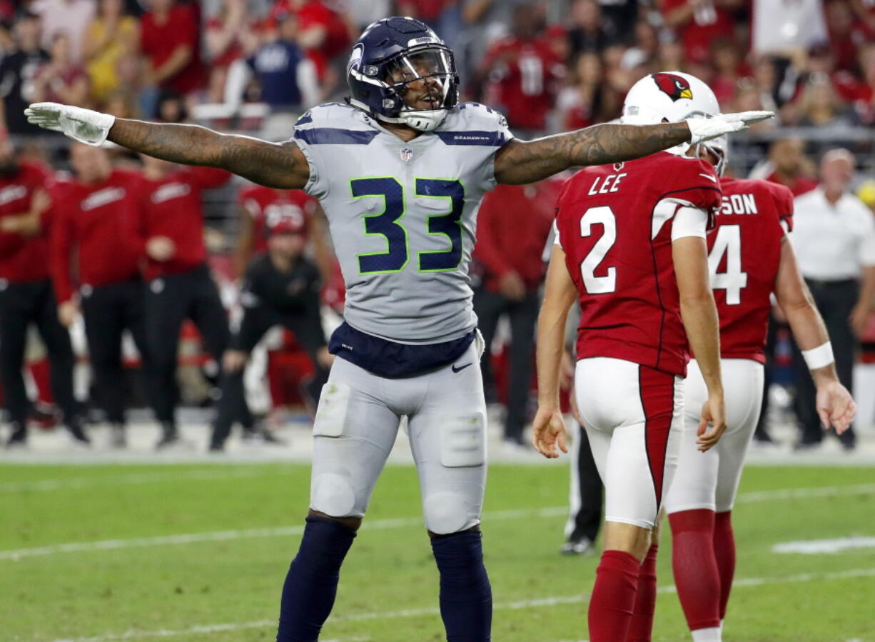 Seattle Seahawks defensive back Tedric Thompson (33) celebrates a missed field goals by Arizona Cardinals kicker Phil Dawson (4) during the second half of an NFL football game, Sunday, Sept. 30, 2018, in Glendale, Ariz. The Seahawks won 20-17.