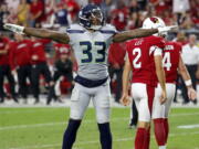 Seattle Seahawks defensive back Tedric Thompson (33) celebrates a missed field goals by Arizona Cardinals kicker Phil Dawson (4) during the second half of an NFL football game, Sunday, Sept. 30, 2018, in Glendale, Ariz. The Seahawks won 20-17.