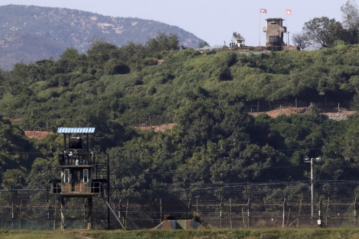 Military guard posts of North Korea, right top, and South Korea, left bottom, are seen in Paju, at the border with North Korea, South Korea. Seoul on Monday, says South Korea has begun clearing mines from two sites inside the heavily fortified border with North Korea under a package of tension-reduction deal between the rivals.