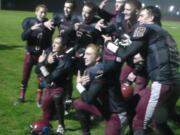 Stevenson football pose in celebration after beating La Center 27-21 on Friday (Tim Martinez/The Columbian)