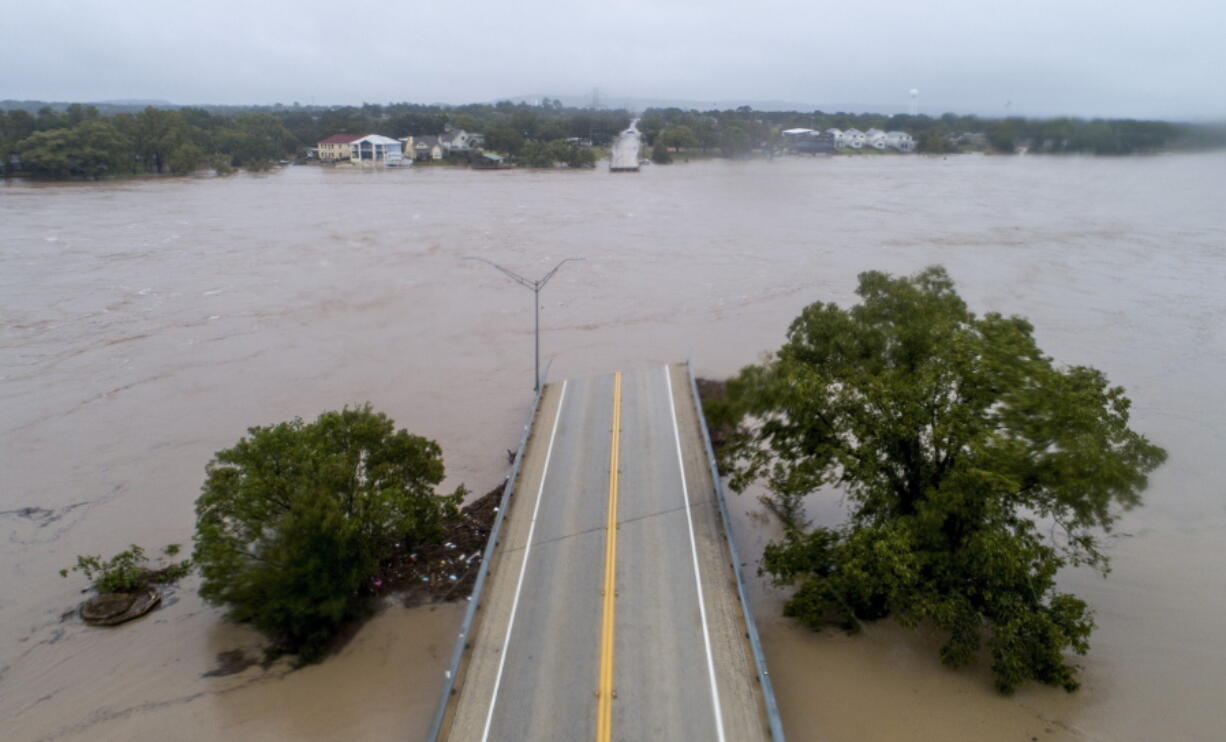 The Llano River flows between the washed out Ranch Road 2900 bridge, Tuesday, Oct. 16, 2018, in Kingsland, Texas.