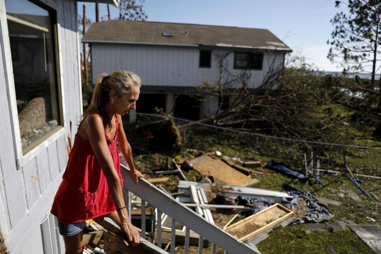 Monica Jones looks out over the debris littering her yard after riding out hurricane Michael in her home in Callaway, Fla., on Thursday. “I didn’t think it was going to be this bad,” said Jones on her decision to stay through the storm. The devastation inflicted by Hurricane Michael came into focus Thursday with rows upon rows of homes found smashed to pieces, and rescue crews began making their way into the stricken areas in hopes of accounting for hundreds of people who may have stayed behind.