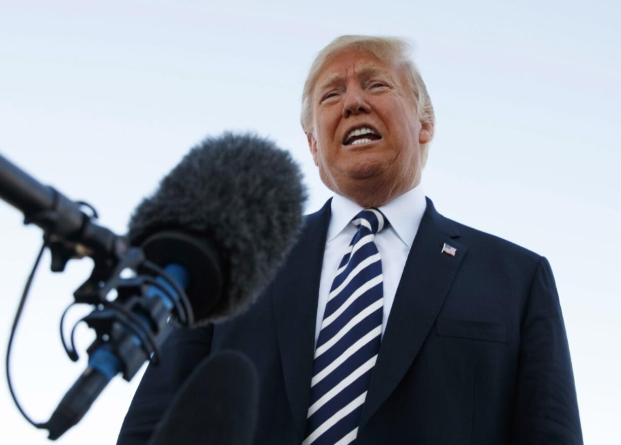 President Donald Trump speaks to media before boarding Air Force One at Elko Regional Airport, Saturday, Oct. 20, 2018, in Elko, Nev., after a campaign rally.