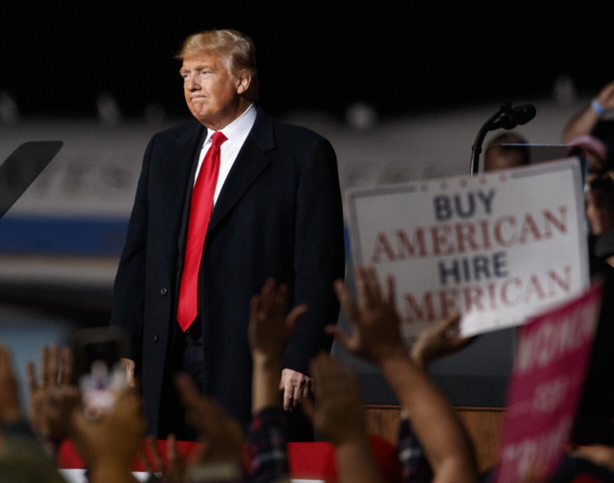 President Donald Trump looks the the cheering audience as he leaves a campaign rally at Minuteman Aviation Hangar, Thursday, Oct. 18, 2018, in Missoula, Mont. Trump’s 2016 campaign was defined by his fiery immigration rhetoric, visions of the undocumented flowing across the border to assault Americans and steal their jobs. Now, in the final weeks before midterm elections, he’s back at it as he looks to stave off Democratic gains in Congress.