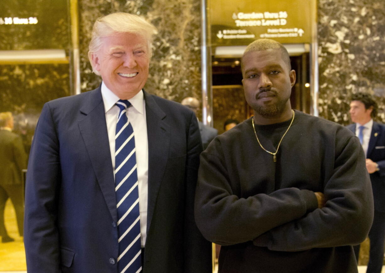 President-elect Donald Trump and Kanye West pose for a picture in the lobby of Trump Tower in New York. Kanye West will visit the White House on Thursday to meet with President Donald Trump and his son-in-law Jared Kushner talk about manufacturing in America, gang violence, prison reform and Chicago violence.