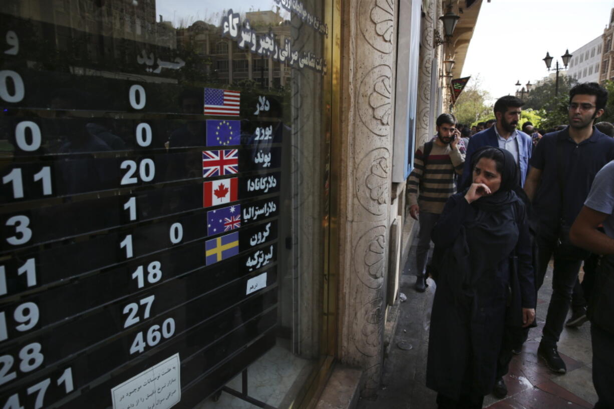 FILE - In this Oct. 2, 2018, file photo, an exchange shop displays rates for various currencies, in downtown Tehran, Iran. A battle is brewing between the Trump administration and some of the president’s biggest supporters in Congress who are concerned that sanctions to be re-imposed on Iran early next month won’t be tough enough.