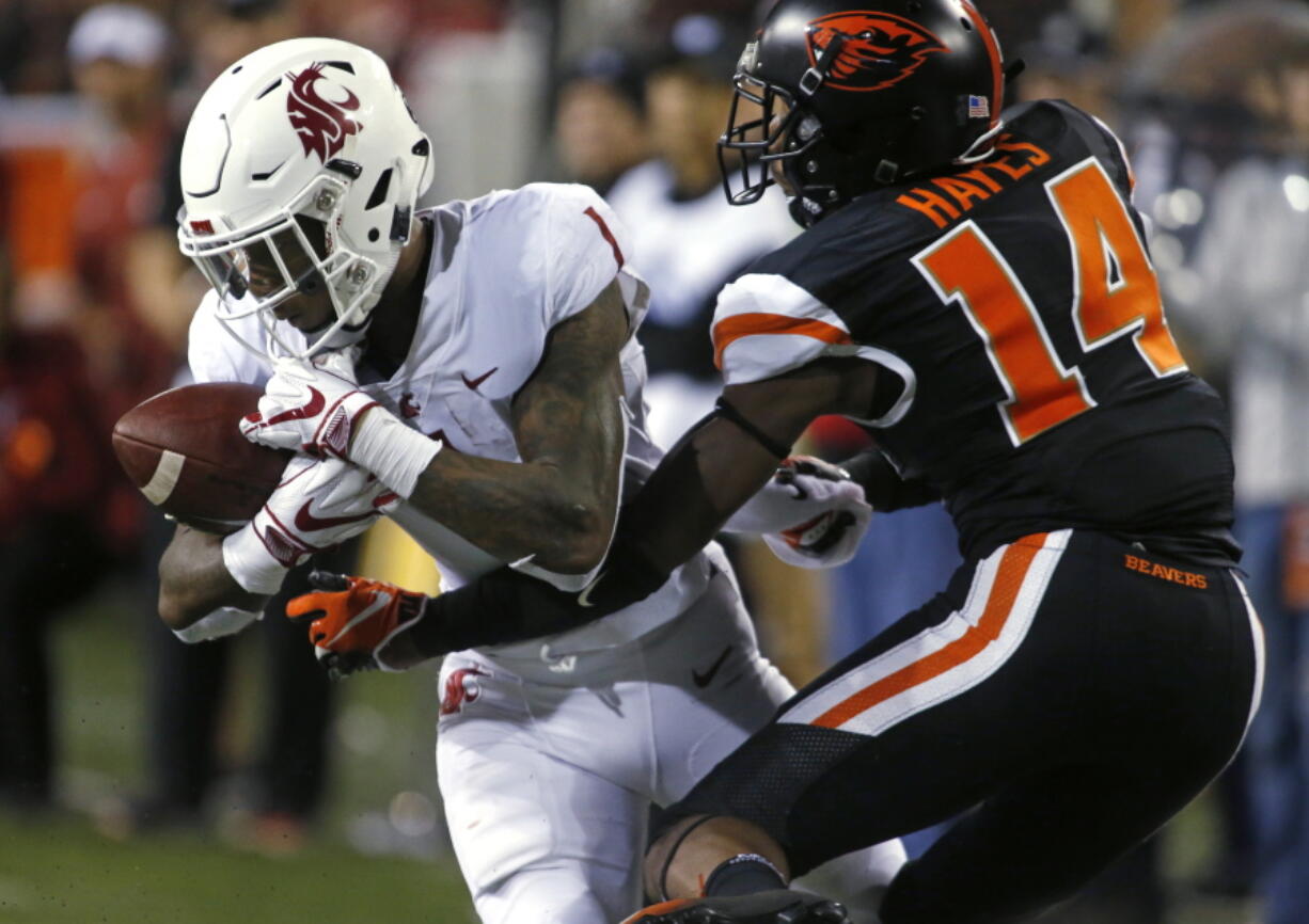 Washington State's Tay Martin (1) makes a catch in front of Oregon State's Kaleb Hayes during the fourth quarter of an NCAA college football in Corvallis, Ore., Saturday, Oct. 6, 2018. (AP Photo/Timothy J.