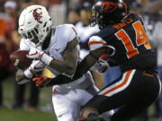 Washington State's Tay Martin (1) makes a catch in front of Oregon State's Kaleb Hayes during the fourth quarter of an NCAA college football in Corvallis, Ore., Saturday, Oct. 6, 2018. (AP Photo/Timothy J.