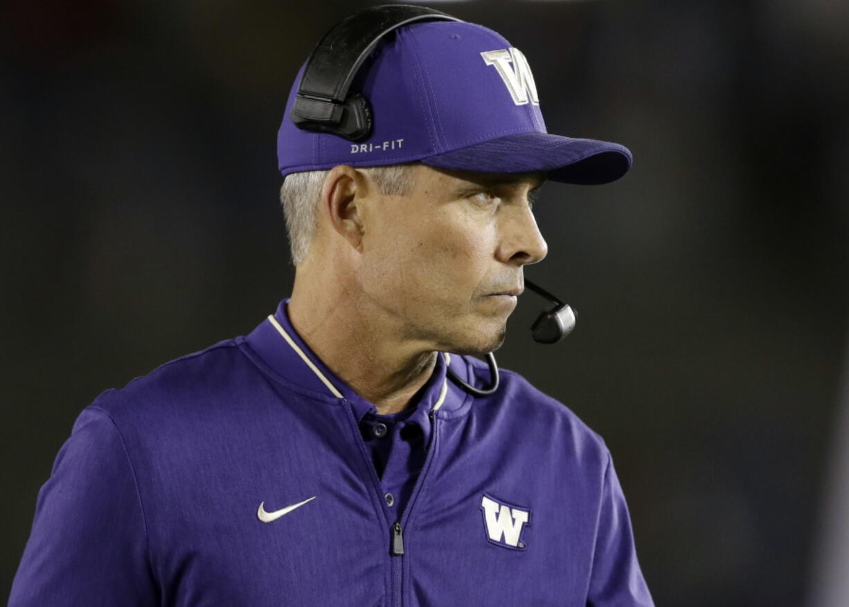 Washington coach Chris Petersen watches from the sideline as his team plays UCLA during the second half of an NCAA college football game Saturday, Oct. 6, 2018, in Pasadena, Calif.