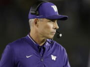 Washington coach Chris Petersen watches from the sideline as his team plays UCLA during the second half of an NCAA college football game Saturday, Oct. 6, 2018, in Pasadena, Calif.