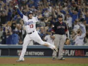 Los Angeles Dodgers’ Max Muncy celebrates after his walk off home run against the Boston Red Sox during the 18th inning in Game 3 of the World Series baseball game on Saturday, Oct. 27, 2018, in Los Angeles. (AP Photo/Jae C.