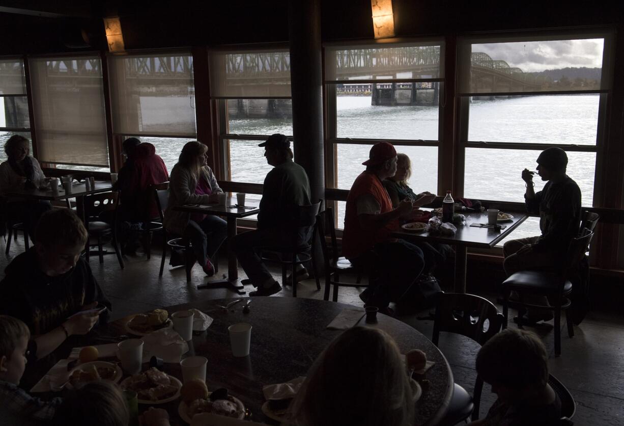 Families and friends enjoy the free Thanksgiving meal at WareHouse '23 in Vancouver last year. The tradition continues this year.