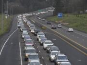 Vehicles traveling east on state Highway 500 stop at the intersection with Falk Road during rush hour.