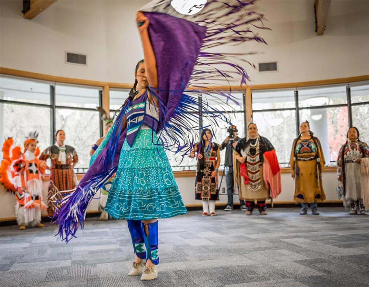 A girl in vibrant purple and turquoise regalia dances at the Water Resources Education Center. The Native American Heritage Festival on Nov. 17 combines a runway show with a holiday craft market from noon to 4:30 p.m.