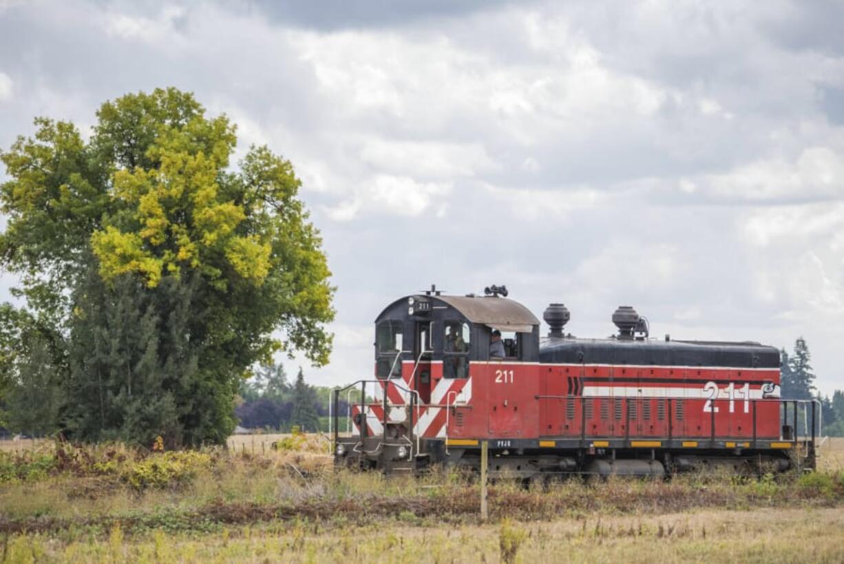 A Portland Vancouver Junction Railroad rail car travels along the Chelatchie Prairie Railroad.