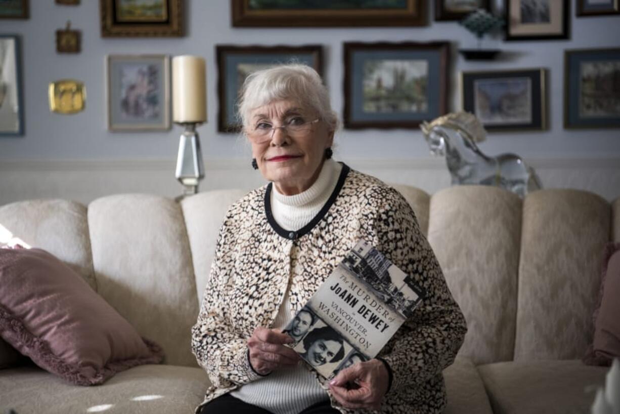 “I am convinced some stories want to be told.” Pat Jollota holds a copy of her book, “The Murder of JoAnn Dewey in Vancouver, Washington,” at her home in Vancouver.