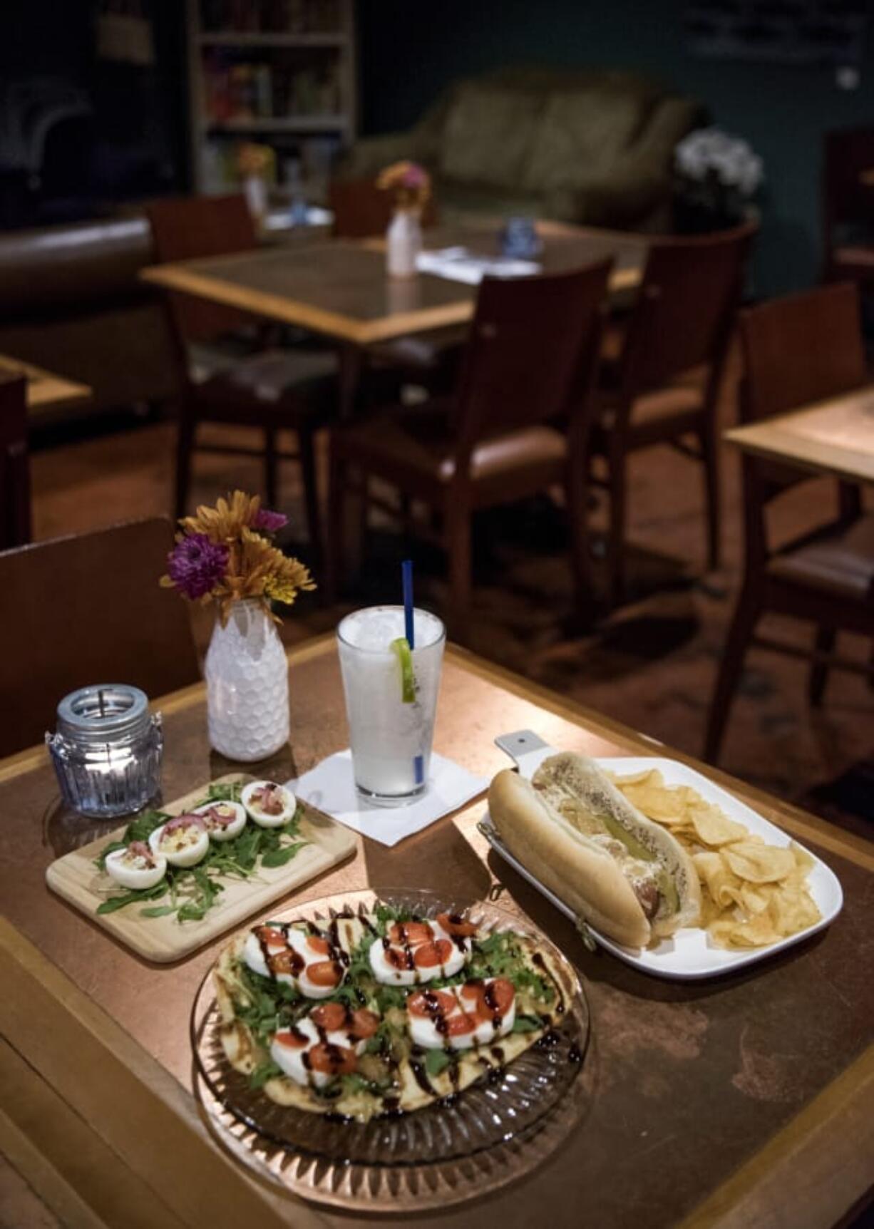 The fancy deviled eggs, from left, clockwise, the Lime in the Coconut cocktail, the Chicago dog, and the UnderBar flatbread.