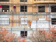 Construction crews work on Our Heros Place at the corner of D Street and East 13th Street in late October. Construction has added jobs steadily throughout this year.