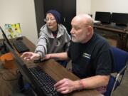 Sheri Hoff describes her plan as Keith Wells, both of Vancouver, helps her put together a pamphlet with all of the resource class times for the Recovery Resource Center in Vancouver. Wells is an AmeriCorps VISTA member, and he manages the center.