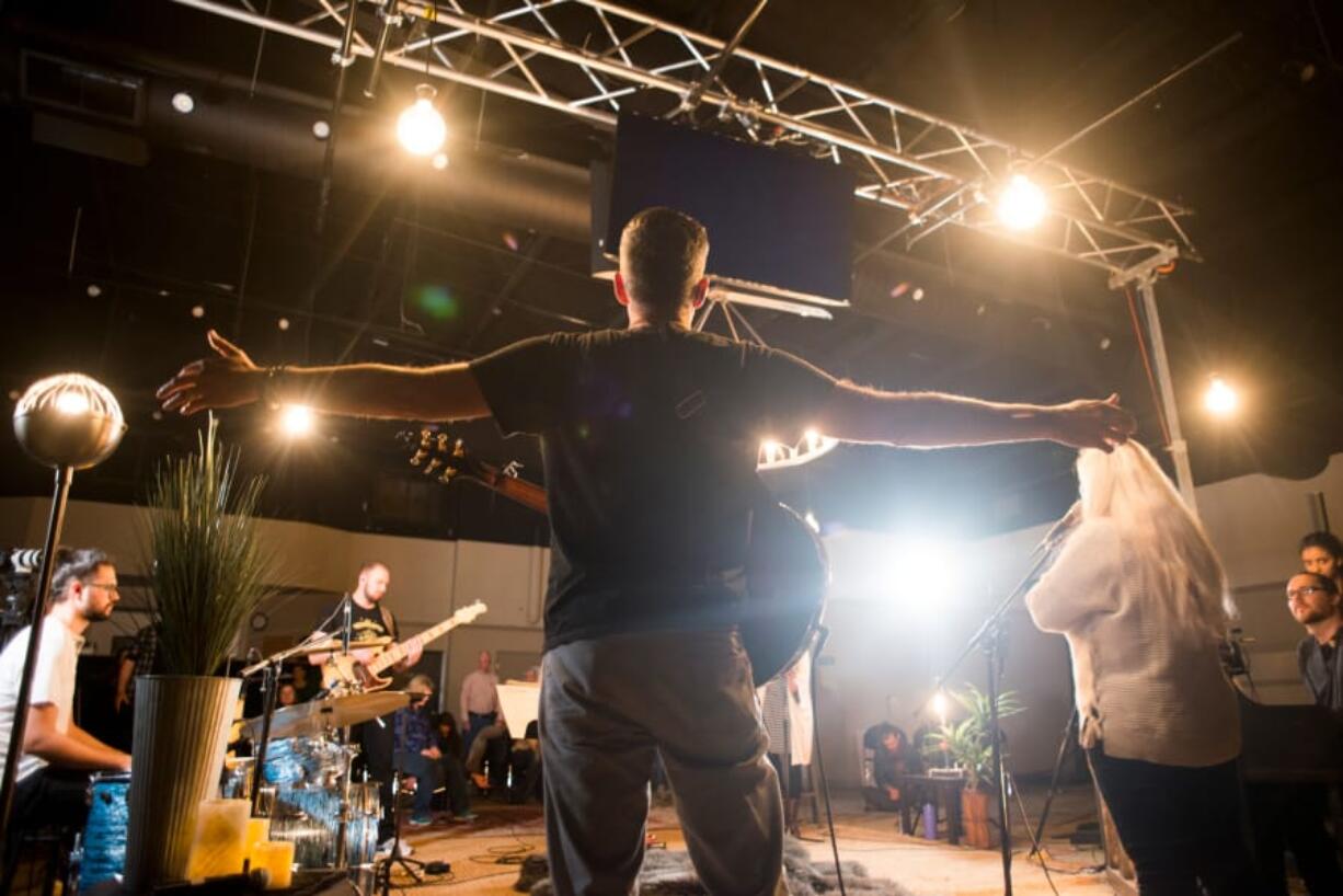 Jonathan Tutt spreads his arms while playing guitar for Unfiltered, a Friday night worship service at Living Hope Church’s chapel in Vancouver. He said they plan maybe 30 percent of the evening. “Sometimes it’s really spontaneously great and sometimes it spontaneously falls flat,” Tutt says.