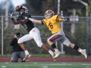 Union's Darien Chase completes a catch for a touchdown against an Enumclaw defender at McKenzie Stadium Friday night, Nov. 2, 2018.