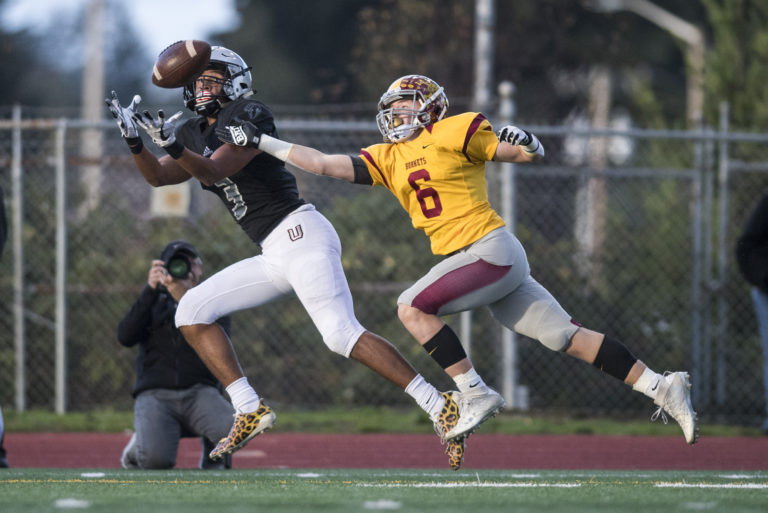 Union's Darien Chase completes a catch for a touchdown against an Enumclaw defender at McKenzie Stadium Friday night, Nov. 2, 2018.