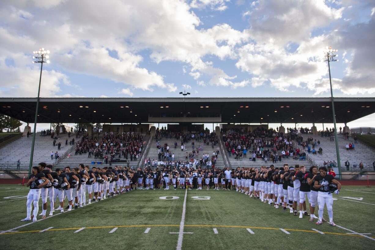 The Union Titans line up in the shape of a U for the National Anthem before their game against Enumclaw at McKenzie Stadium Friday night, Nov. 2, 2018.