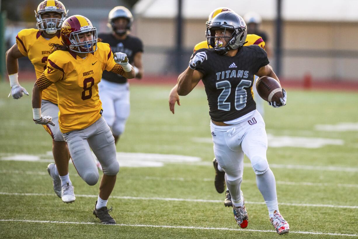 Union's Joseph Siofele breaks away from Enumclaw defenders to run in a touchdown at McKenzie Stadium Friday night, Nov. 2, 2018.