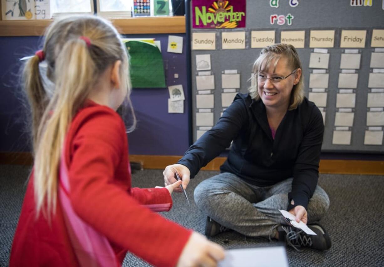 Teresa Tollen, owner of Teresa’s Little School in La Center, gives student Harlow Webb handouts for a geometric shape exercise during class last week in La Center. Teresa’s Little School has been open for three years and recently expanded to accommodate more students.