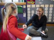 Teresa Tollen, owner of Teresa’s Little School in La Center, gives student Harlow Webb handouts for a geometric shape exercise during class last week in La Center. Teresa’s Little School has been open for three years and recently expanded to accommodate more students.