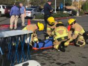 Salmon Creek: Clark County Fire District 6 firefighters help a victim of a 10.4 magnitude earthquake during a training scenario Oct. 18 at Legacy Salmon Creek Medical Center.