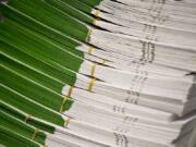 Stacks of ballots wait to be inspected by officials at the Clark County Elections Office in 2018.