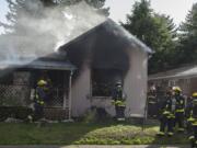 Vancouver firefighters work at the scene of a house fire at 1105 East 29th Street on Friday afternoon, Nov. 2, 2018. One woman was reportedly severely injured in the blaze.