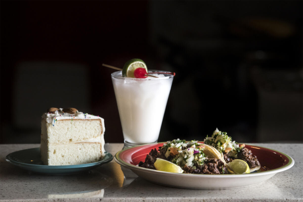 Old Fashion Almond Cake, a Lime in the Coconut cocktail and carne asada tacos are seen here at Provecho on Thursday afternoon, Nov. 8, 2018.