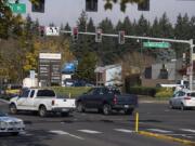 Motorists run through a red light at the intersection of Southeast Mill Plain Boulevard and Chkalov Drive. About a decade ago, the city considered putting a red-light camera at the intersection but never did. Since then, both the city and the county have opted for a different approach to policing red-light scofflaws.