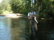 In this 2009 photo, Jeff Jolley, then with the U.S. Fish and Wildlife Service, holds a Western pearlshell mussel found in Salmon Creek.