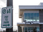 A sign notifying drivers they need to pay to park is seen in front of Twigs Bistro on Tuesday.