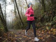 Jane Connell jogs near Lacamas Lake in Camas. Connell will participate in a fundraiser challenge to help her daughter get a track wheelchair. Connell will run or walk 4 miles every four hours for a 48-hour period, starting tonight.