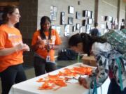 Ridgefield: Ridgefield School District office staff Dani Taylor, left, and Kalin Heath get Ridgefield High School students to pledge their support during National Bullying Prevention Month.