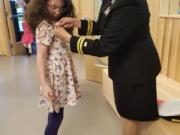 Camas: Navy Lt. Ingrid Rojas attended Lacamas Lake Elementary School’s Veterans Day assembly with Skylar Gregory as a stand-in for her grandfather, a World War II vet who died in 2001.