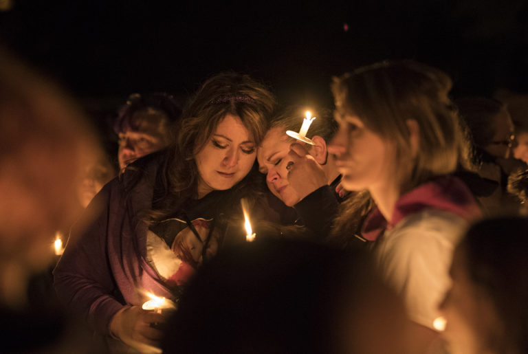 Tomisa Bates, left, and Sheila Crosslin share a quiet moment with the crowd during a candlelight vigil in honor of Hartley Anderson, 5, at LeRoy Haagen Memorial Park on Friday evening, Nov. 9, 2018.