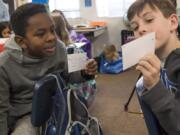 Malcolm Weatherspoon, left, and Brayden Sherriffs compare notes during a vegan nugget taste test at Fisher’s Landing Elementary School.