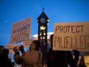 Debra Samuel, left, and Connie Hewitt, right, both of Vancouver, hold up signs as they gather at Esther Short Park for the "Nobody is Above the Law" rally on Thursday, Nov. 8, 2018. The nationwide rallies and marches are protesting the implications of President Donald Trump's dismissal of Attorney General Jeff Sessions and its potential effect on the Mueller investigation into Russia meddling in the 2016 election.