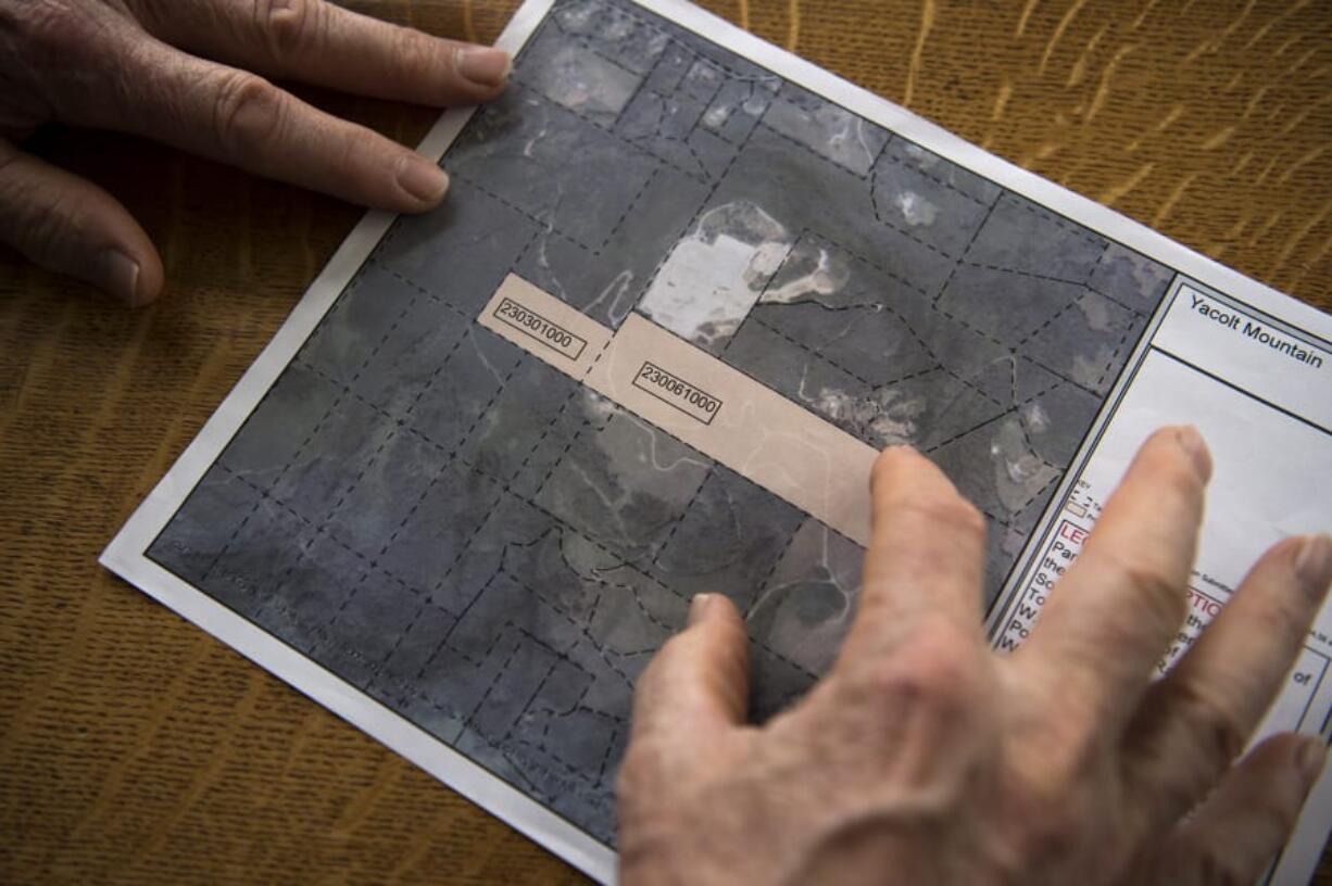 Gary Ogier looks at a map of proposed overlay near the Yacolt Mountain Quarry that has him and other neighbors concerned.