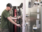 Tracker Safe co-owner Luke Boyer of Vancouver displays one of the popular American Security brand safes at the Tracker Safe shop in Vancouver on Wednesday. Boyer said he noticed an uptick in customers last week after I-1639 passed, tightening laws surrounding safe gun storage.