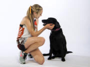 Washougal senior Amelia Pullen, the all-region girls cross country runner of the year, is pictured with her Black Labrador Cienna on Tuesday, Nov. 13, 2018.