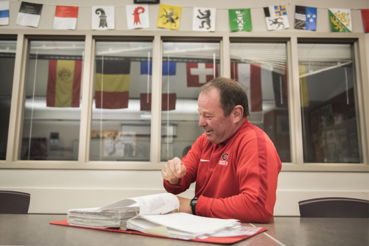 Camas Soccer Coach Roland Minder looks through a notebook containing notes from a past season in his classroom at Camas High School on Tuesday afternoon, Nov. 13, 2018.