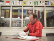 Camas Soccer Coach Roland Minder looks through a notebook containing notes from a past season in his classroom at Camas High School on Tuesday afternoon, Nov. 13, 2018.