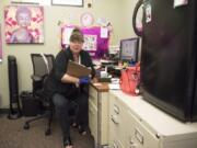 Ronda J. Harrison, care navigator at the Veterans Affairs Rapid Response Clinic in Vancouver, checks a patient’s chart.